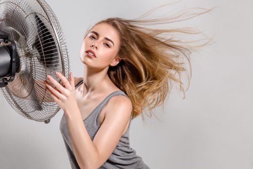 Young woman with cooler fan